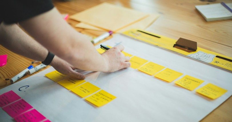 person writing on white paper